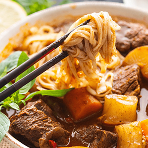 A bowl of Bo Kho with noodles